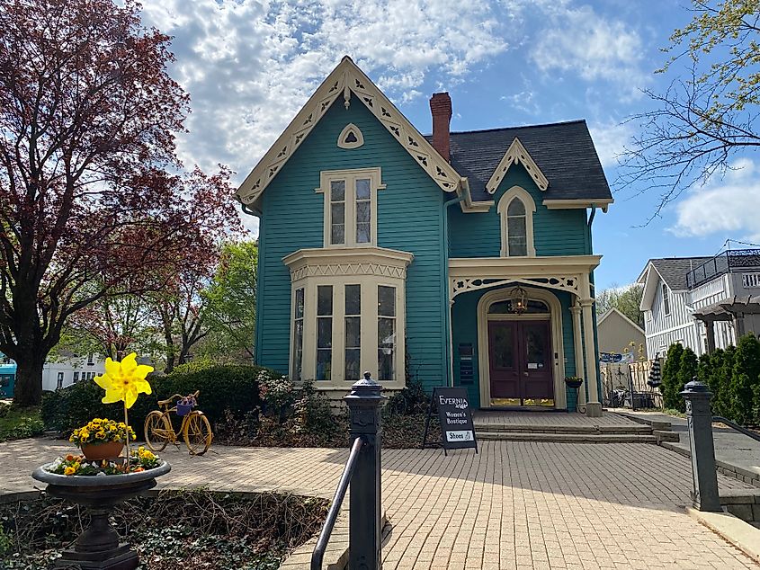 A stately blue house now operating as a women's clothing boutique.