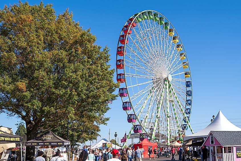 The Bright Colors of the Giant Ferris Wheel are an Attraction on the North Carolina State Fair Midway.