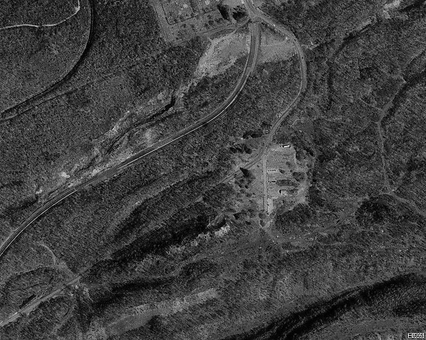 1999 photo showing the abandoned highway and its replacement