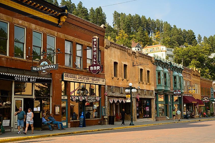 DEADWOOD, SD, USA - SEPTEMBER 15, 2020: Historic saloons, bars, and shops bring visitors to Main St. in this Black Hills gold rush town, famous for Wild Bill Hickok and Calamity Jane.