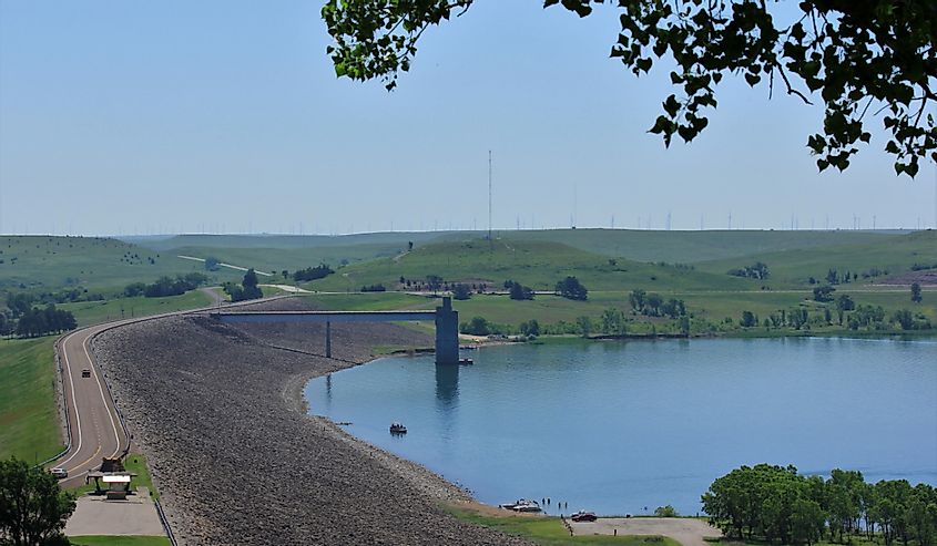 A shot of Wilson Lake from Look Out Point with a view of the Dam with the water,tree's and the Highway going over the Dam with a blue sky.