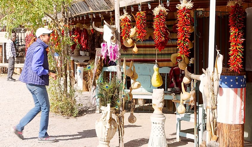 Tourist looking at the ristras hanging in front of the store in Mesilla, New Mexico.