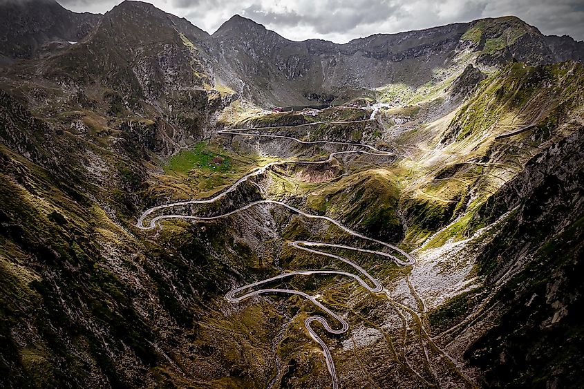 Fotografie aeriană a unei autostrăzi alpine strâmte, întortocheate. 
