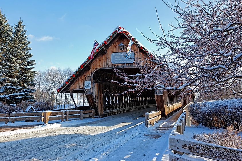 Holz Brucke Wooden Covered Bridge in Frankenmuth, Michigan surrounded by a snowy winter scene