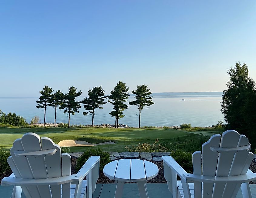View of the 18th Green view and white Adirondack chairs at The Bay Harbor Golf Club in Michigan.