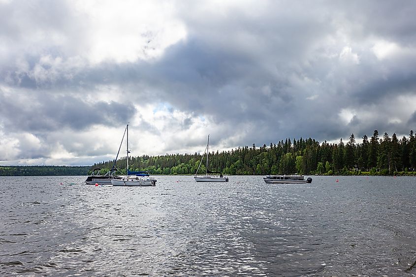 Boats on the water in Clear Lake in Wasagaming, Manitoba during a cloudy day