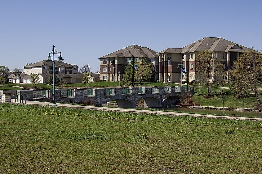 Homes, walking bridge and trail, and pond at North Liberty's Liberty Centre area.