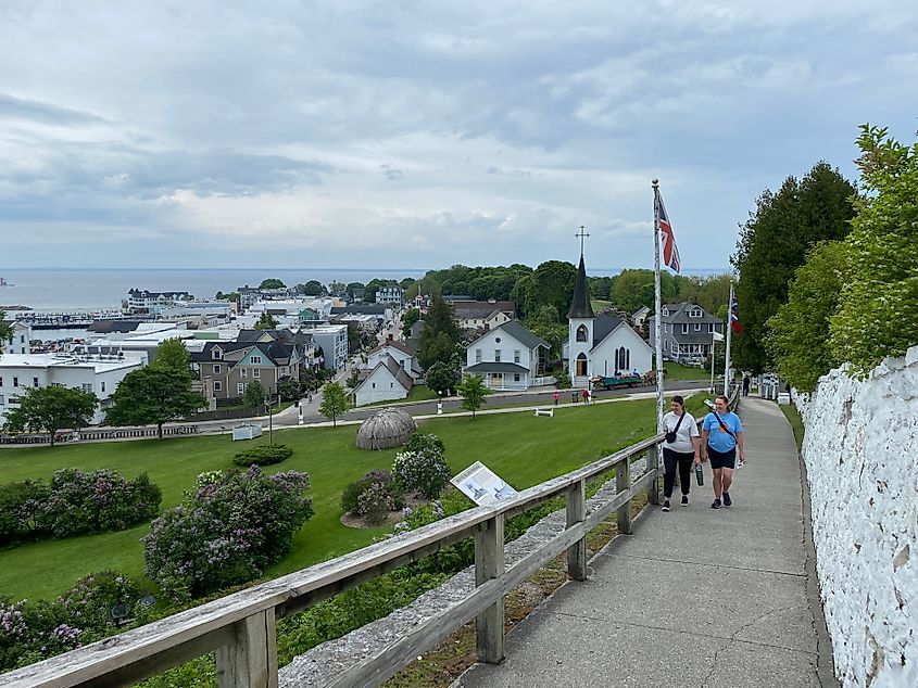 Two women walking up a ramp above Mackinac Island's authentic Victorian village