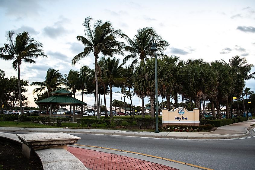 Marina and park with palm trees, grass, water in Fort Pierce, Florida with sidewalk, boardwalks and bridges to walk and ride along the path, via Dawn Damico / Shutterstock.com