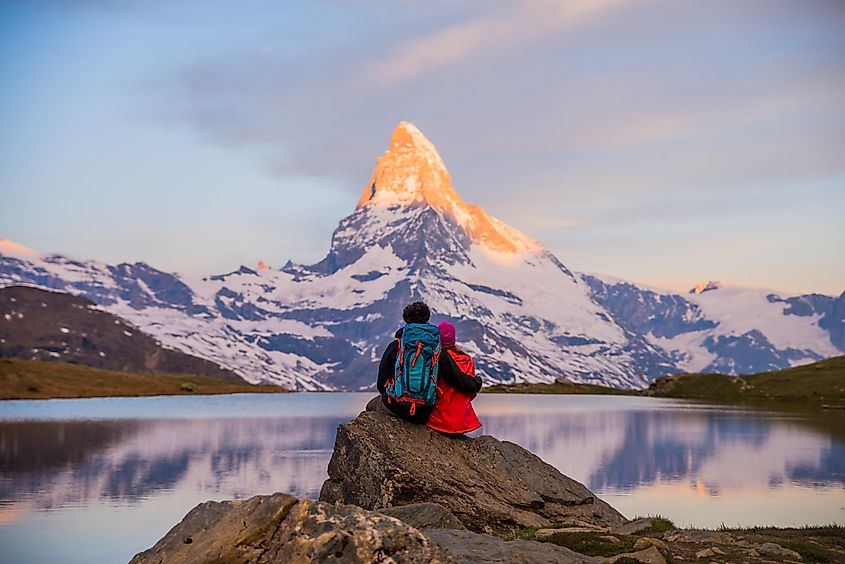 Romantic couple at sunrise, from lake Stellisee, Swiss Alps , Matterhorn Peak, Zermatt,