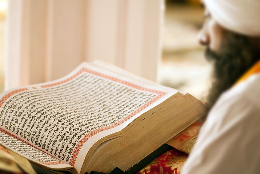 A holy man reading the Guru Granth Sahib