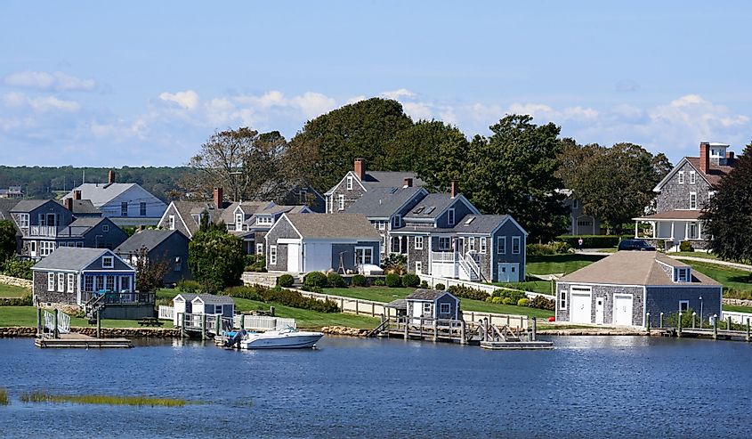 Waterfront houses in this historic coastal village on a clear summer day. Weathered cedar shingles with white painted trim are the typical house style, Westport Point