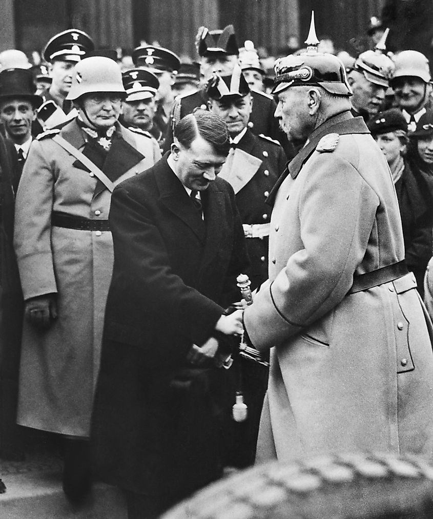 Newly appointed Chancellor Adolf Hitler greets President von Hindenburg at a memorial service. Berlin, 1933. Behind Hitler is Herman Goering and Joseph Goebbels. Editorial credit: Everett Collection / Shutterstock.com