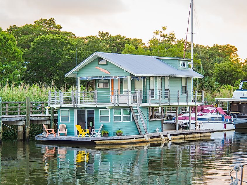 A colorful houseboat residence docked on Apalachicola Bay in the town of Apalachicola
