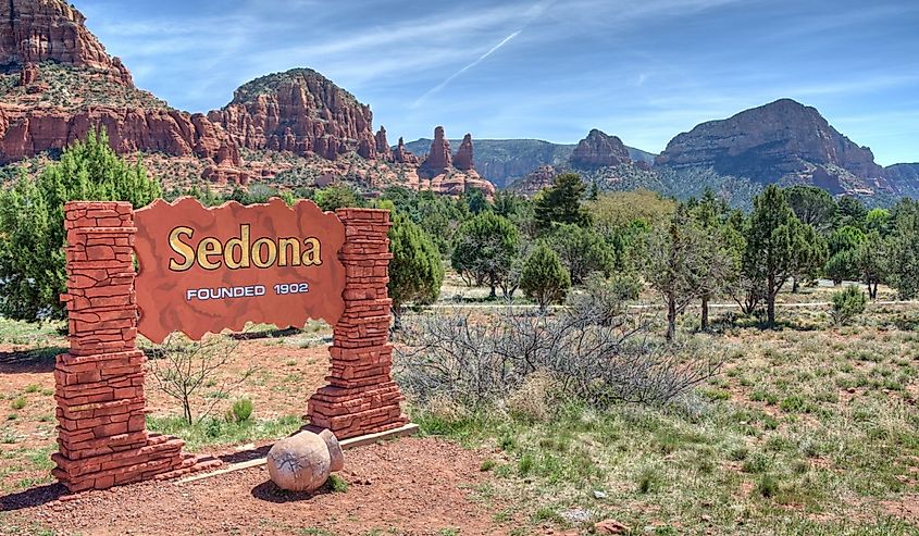 Welcome Sign To Sedona Arizona With A Scenic Background