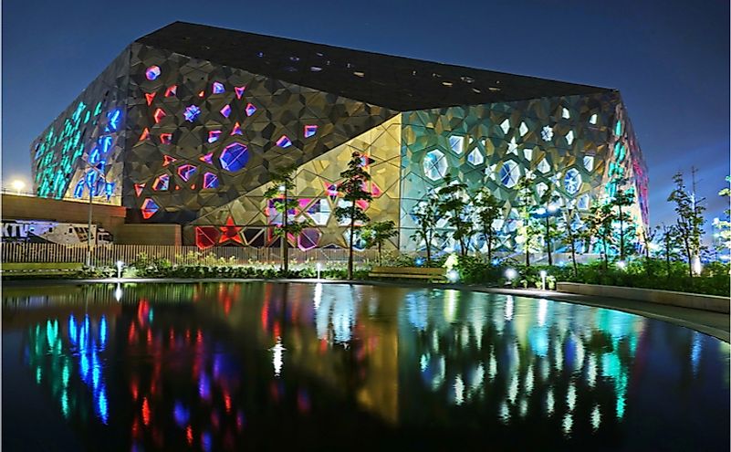 The building of Sheikh Jaber Al Ahmad Cultural Centre, night background with reflection in the water. Editorial credit: MikeDotta / Shutterstock.com