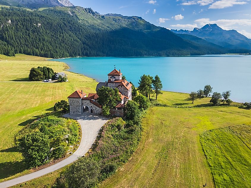 Aerial view of Historic Castle Crap da Sass overlooking Lake Silvaplana, St. Moritz, Grisons Canton, Maloja Region, Switzerland.