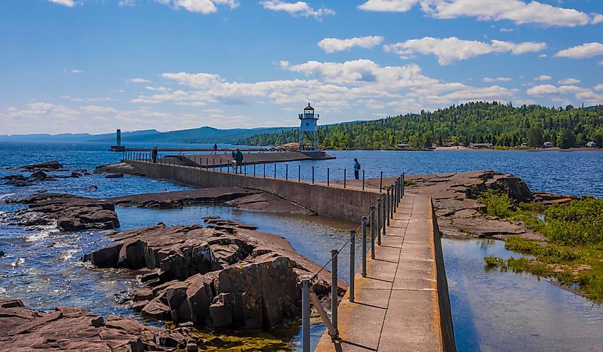 Grand Marais Lighthouse against the backdrop of the Sawtooth Mountains on Lake Superior