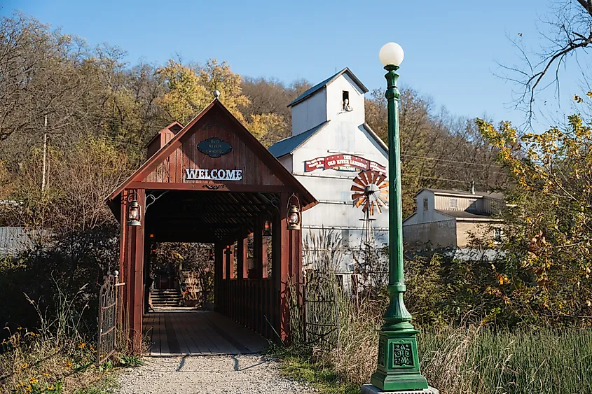 A covered footbridge leading to a salvage yard.