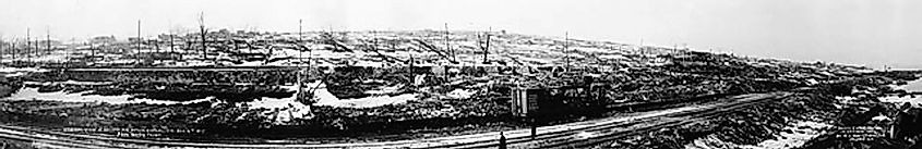 View from the waterfront looking west from the ruins of the Sugar Refinery across the obliterated Richmond District several days after the explosion. The remains of Pier 6, site of the explosion, are on the extreme right.