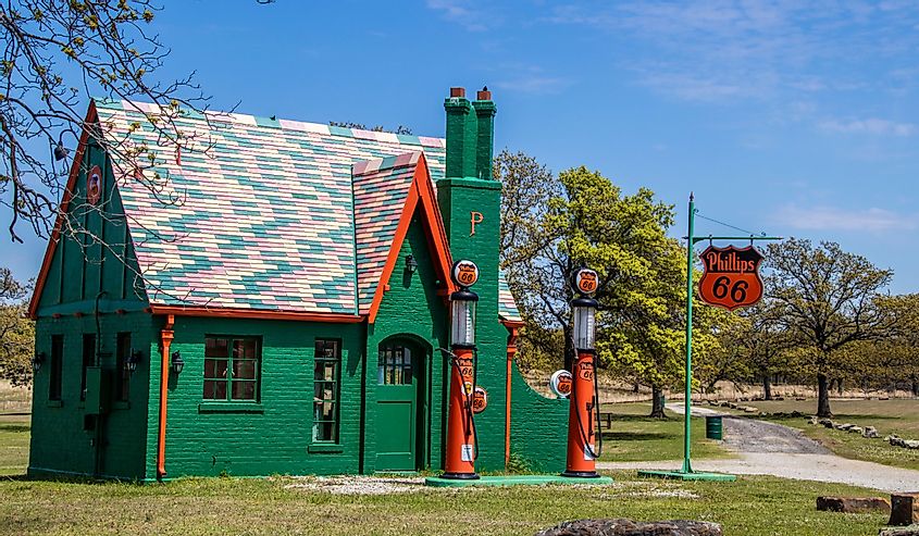  Colorful Retro Phillips 66 Gas Station surrounded by trees with old time signs and pumps