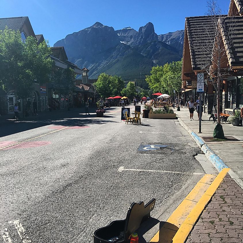 A pedestrian street in a sunny mountain town. 