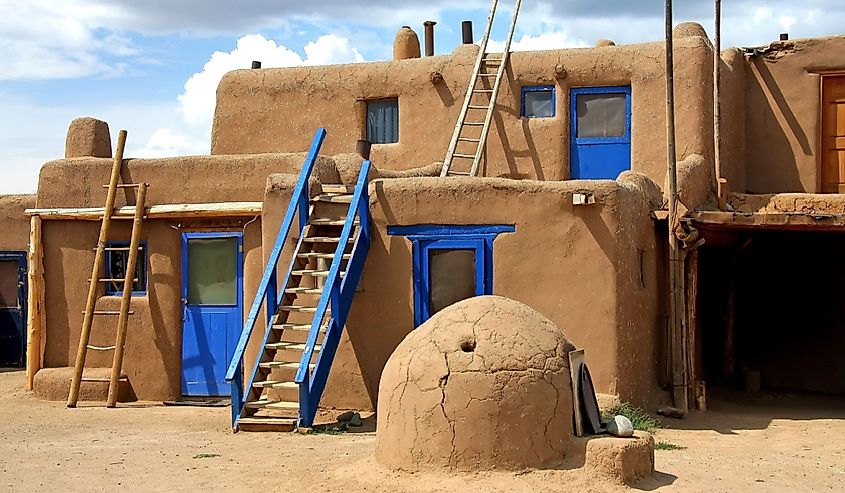Image of Taos Pueblo with ladders and doors. 