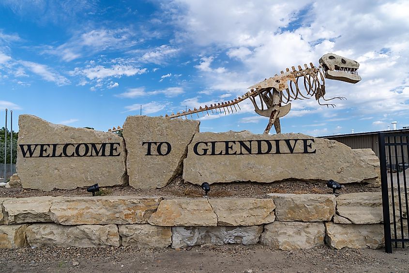 Welcome to Glendive sign features a dinosaur skeleton, as the town is known for fossils. Editorial credit: melissamn / Shutterstock.com