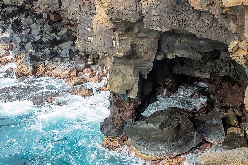 The Holei Sea Arch along the rugged coast of the Volcanoes National Park on Hawaii Big Island, created by lava flows from the Kilauea volcano.