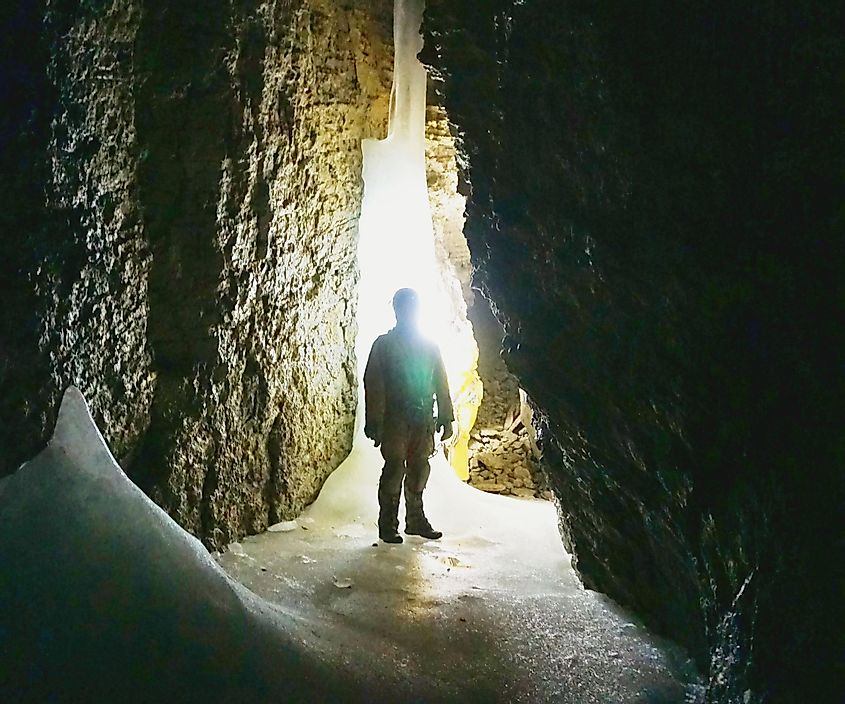 A caver stands in frozen passage near the entrance to Tears of the Turtle Cave