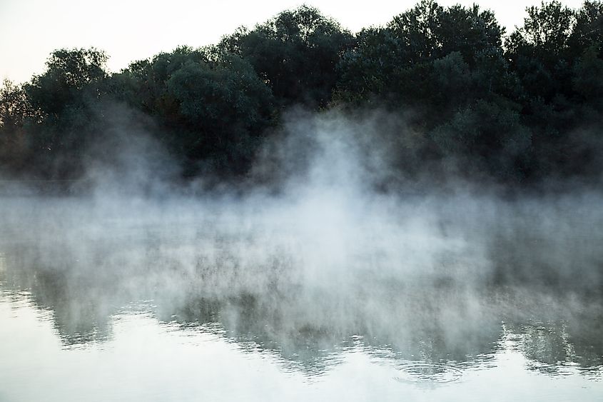Editorial Photo Credit: AlexReut via Shutterstock. morning evaporation of water over the river, fog over the water