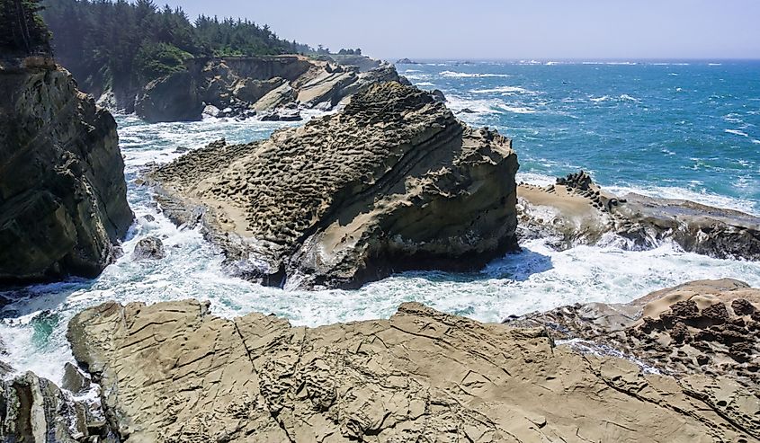 Dramatic shoreline with strange rock formations at Shores Acres State Park, Coos Bay, Oregon