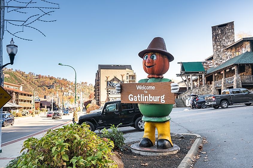 Street-level view of Gatlinburg, Tennessee, bustling with attractions against the backdrop of the Smoky Mountains, taken in October.