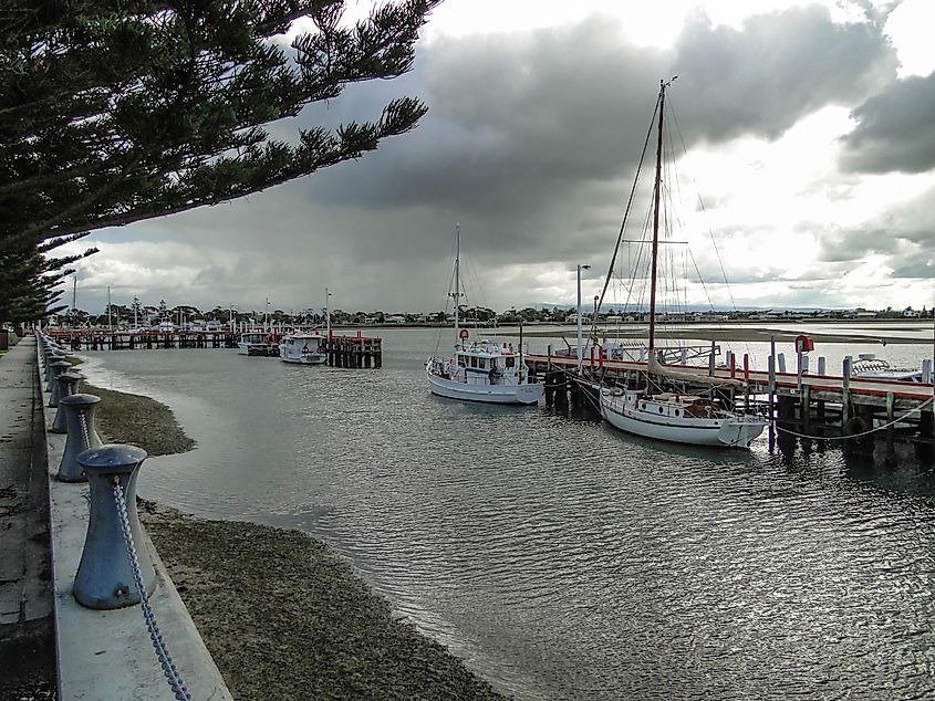 The wooden wharf at Port Albert, Victoria, Australia. There are several fishing boats moored at the wharf.