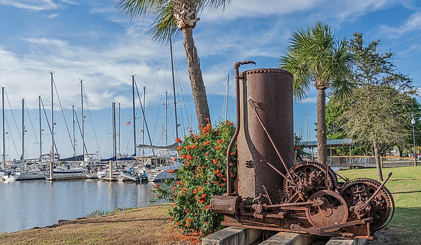 This is old hoist motor with a beautiful view of a shipyard in the background and was photographed in Brunswick, Georgia.