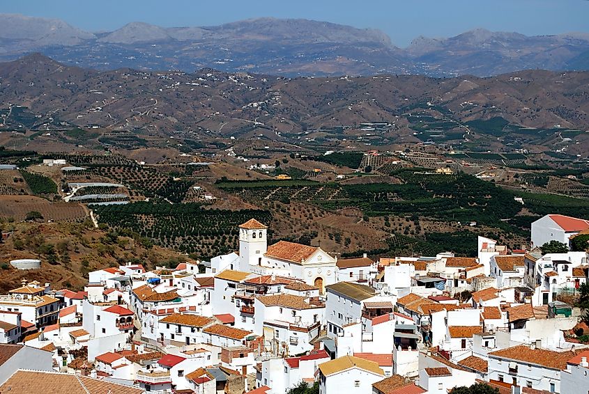 View of the whitewashed village and surrounding countryside, Iznate, Spain.