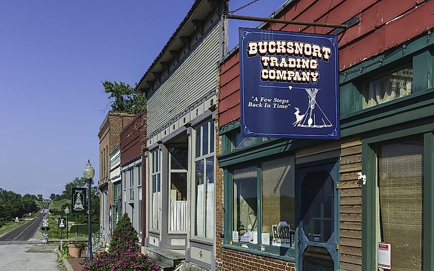 Shop fronts with hoardings along the main street with view of highway to Arrow Rock on a bright sunny afternoon, via Daniel J. Rao / Shutterstock.com