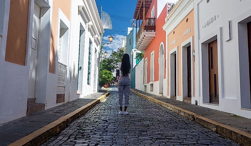 Woman on the cobblestone street of Old San Juan Historic District. 