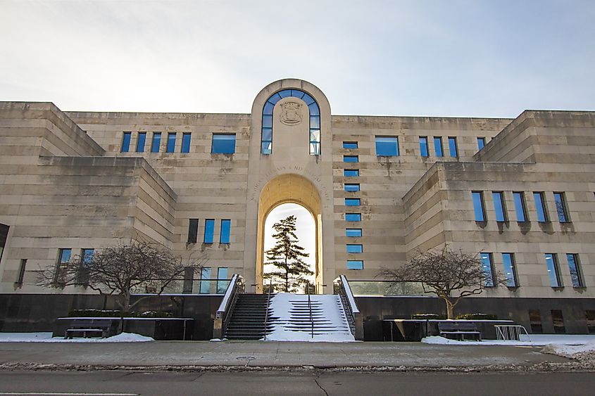 Editorial Photo Credit: ehrlif via Shutterstock. Lansing, Michigan, USA - January 20, 2018: Exterior of the Michigan History Center, state library and archives in the downtown district of Lansing Michigan.