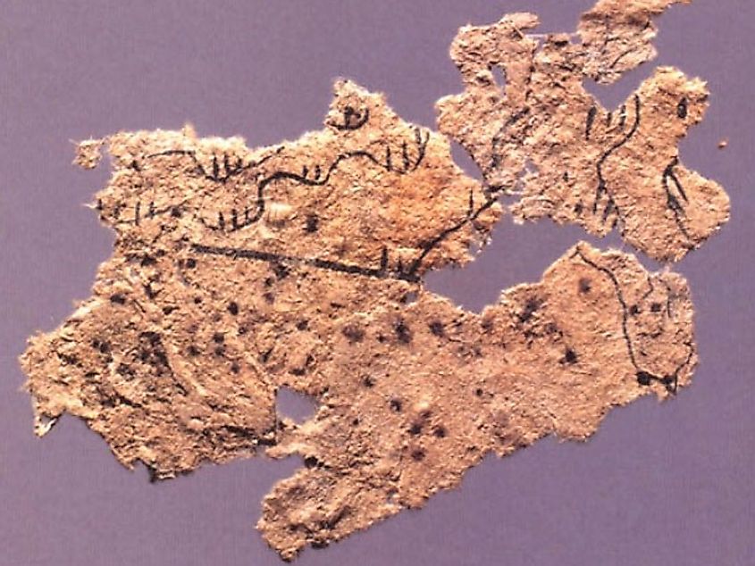 Fragment of a paper map showing topographic features drawn in black ink, found on the chest of the occupant of Tomb 5 of Fangmatan, Gansu in 1986.
