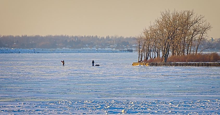 Ice fishermen walking on the ice-covered Lake Erie