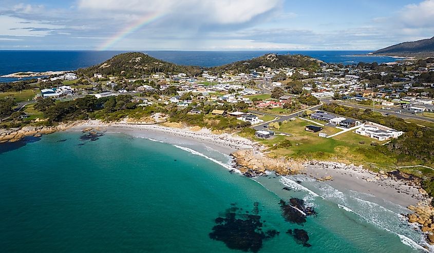 Overlooking Bicheno, Tasmania and the beach with a rainbow in the sky.