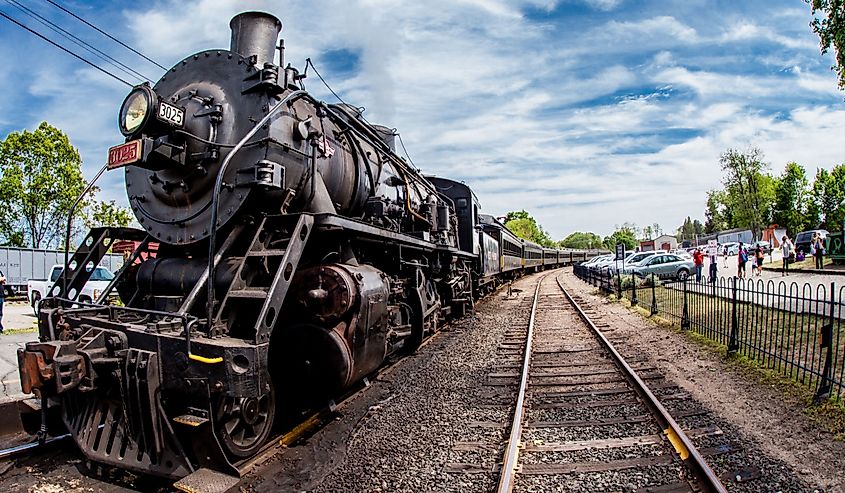 Connecticut Valley Railroad Steam Train Locomotive in train station with nice blue sky and clouds, Essex