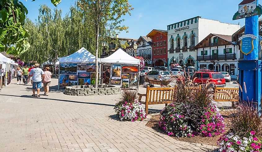 Main tourist street with art show and Bavarian style buildings in Cascade Mountain village of Leavenworth, Washington
