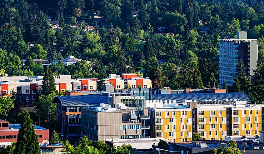 Panorama of downtown residential and commercial district of Eugene, Oregon set in the midst of lush green trees.