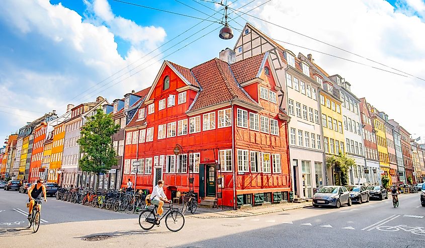 Sunny evening in Copenhagen old town with colorful houses and cyclists