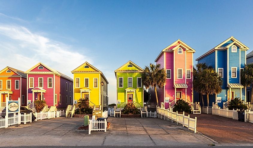 Photo of a row of colorful beachfront homes on a beautiful afternoon in St George Island, Florida