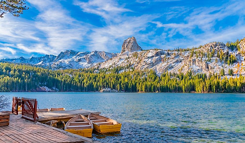 Boats sit at dock at Lake George under the watchful eye of the Crystal Crag peak. This peak is in Mammoth Lakes in Central California, in Sierra Nevada Mountains.
