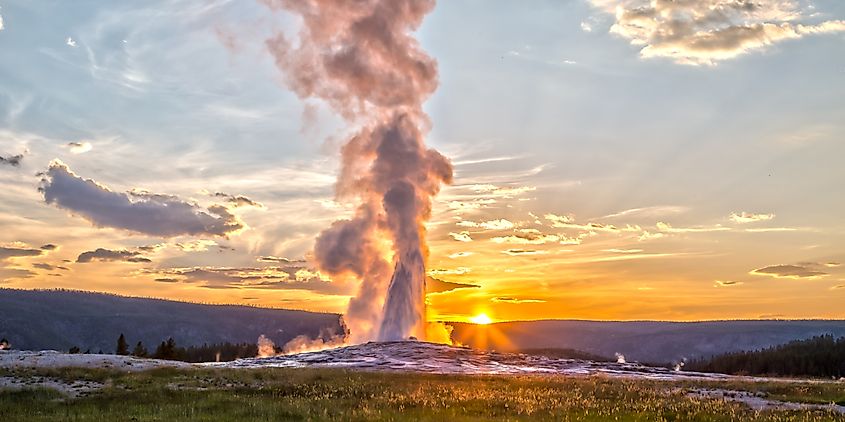 Old Faithful Geyser Eruption in Yellowstone National Park at Sunset