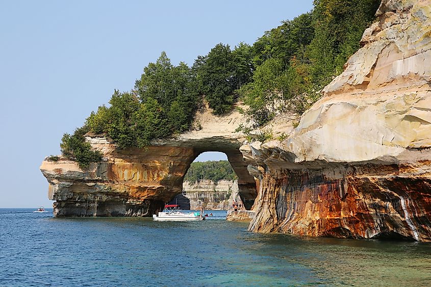 Tourists at Lovers Leap Arch, Pictured Rocks National Lakeshore of Lake Superior, Munising, Michigan.
